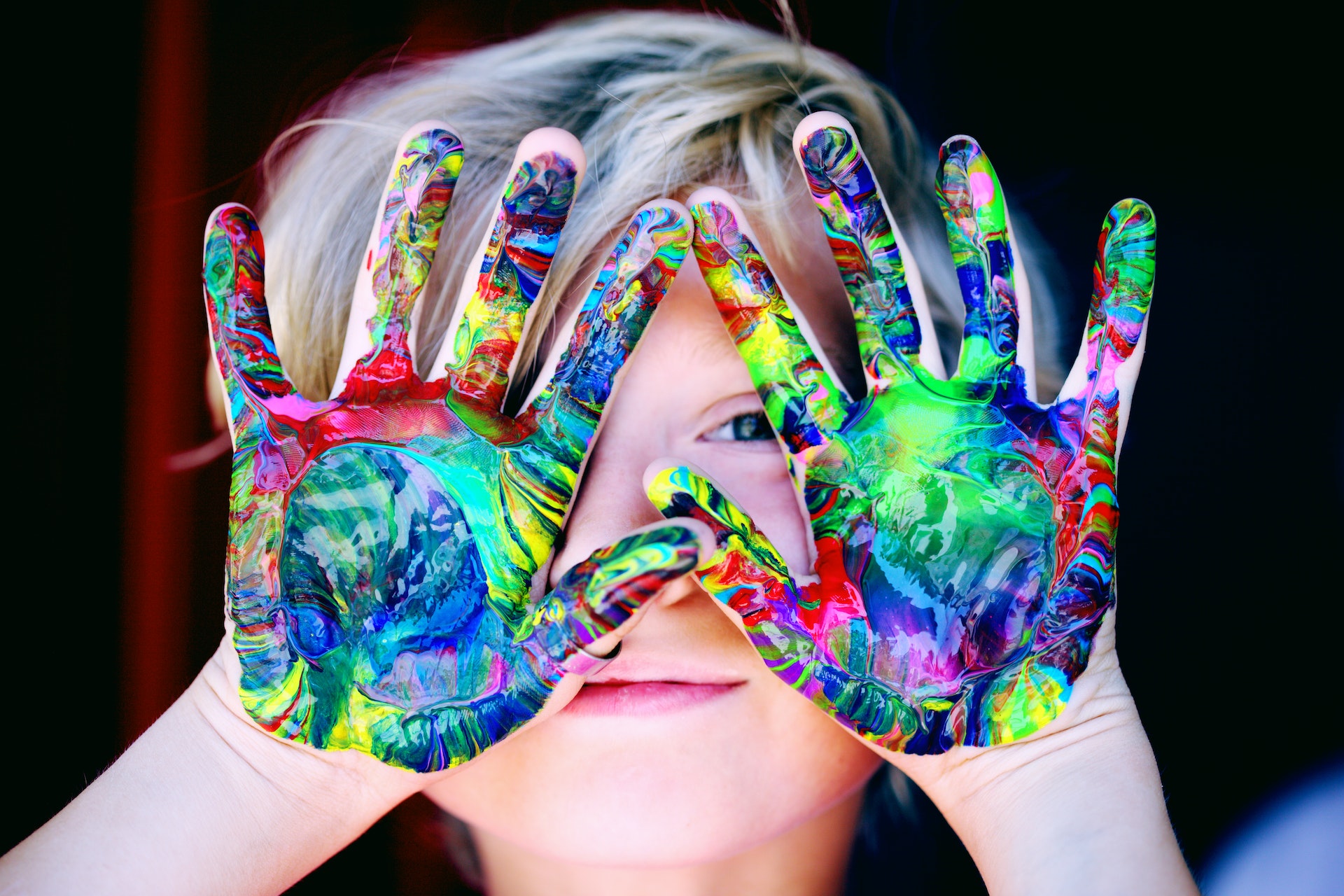 child with paint on their hands
