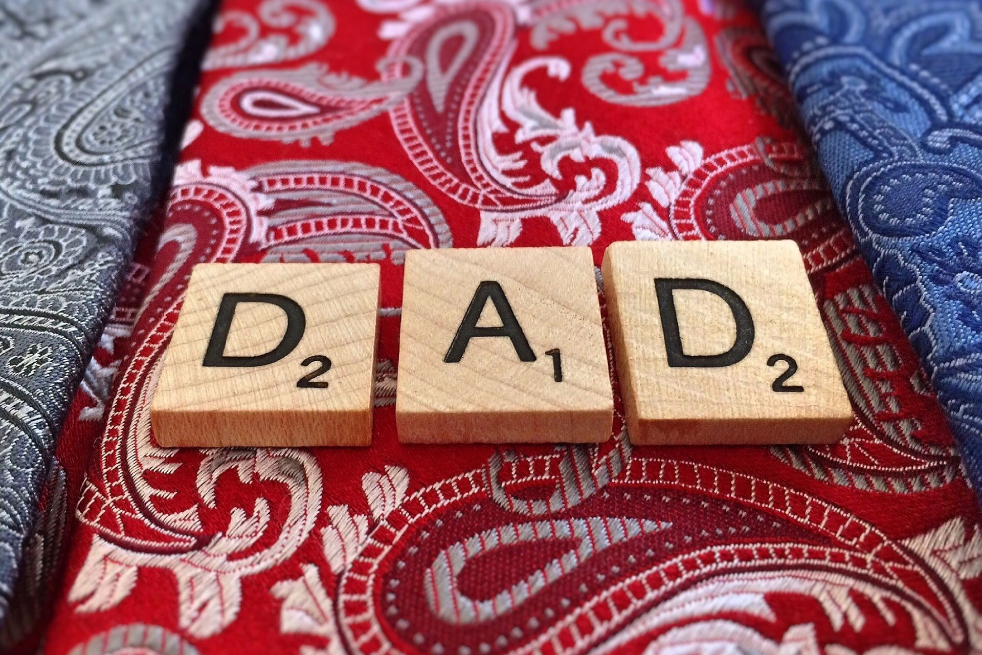 ties with wooden letters on top spelling "DAD"