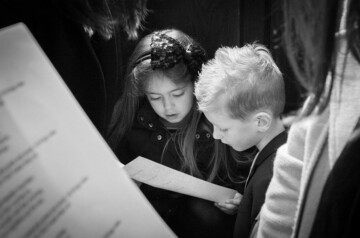 girl and boy singing in church